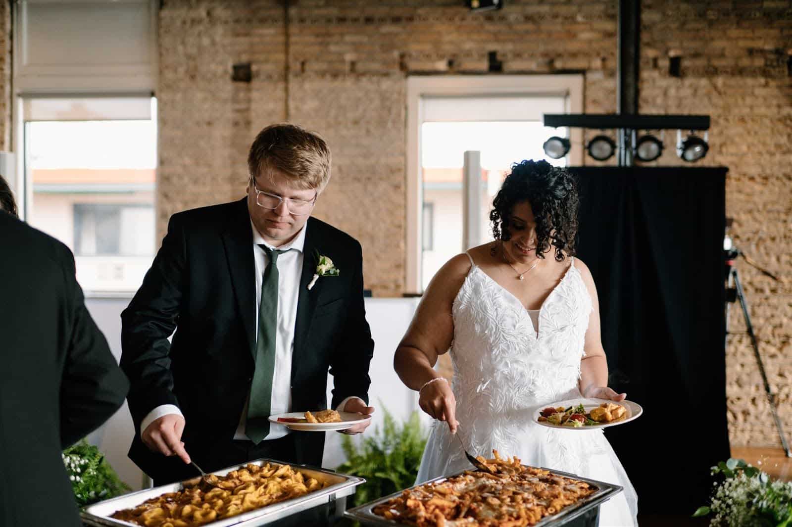 bride & groom serving their plates